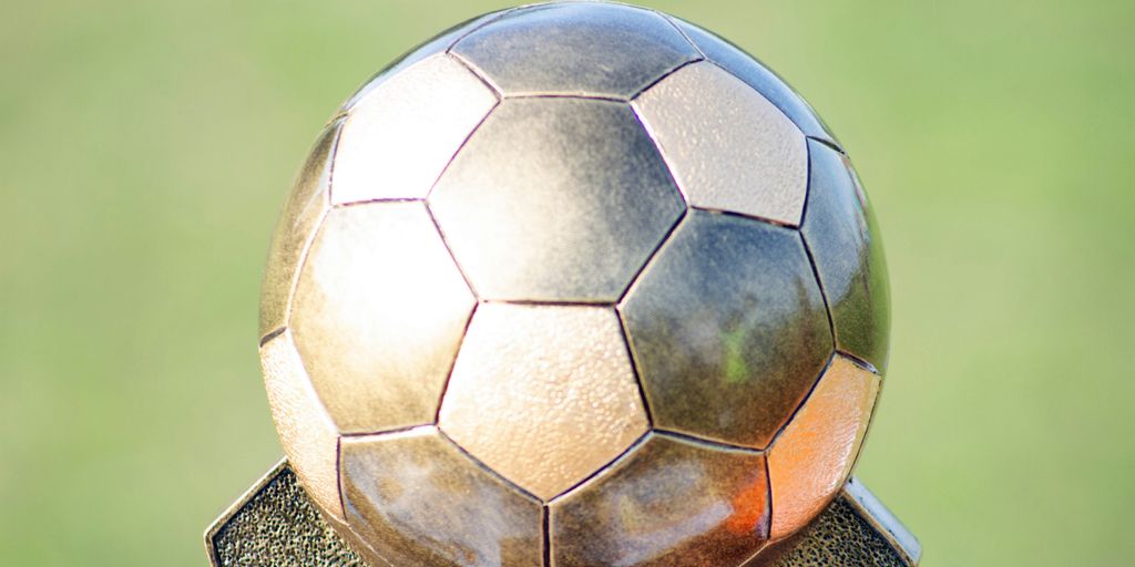 soccer ball on brown wooden stand