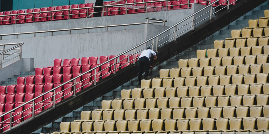 a man with an umbrella is standing on a set of stairs