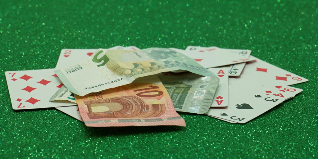a pile of playing cards sitting on top of a green table