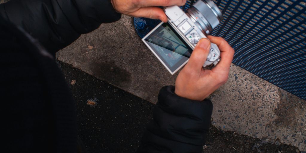 a person holding a cell phone in their hand