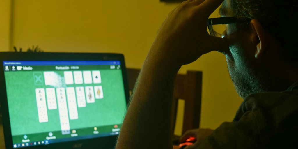 a man sitting in front of a laptop computer