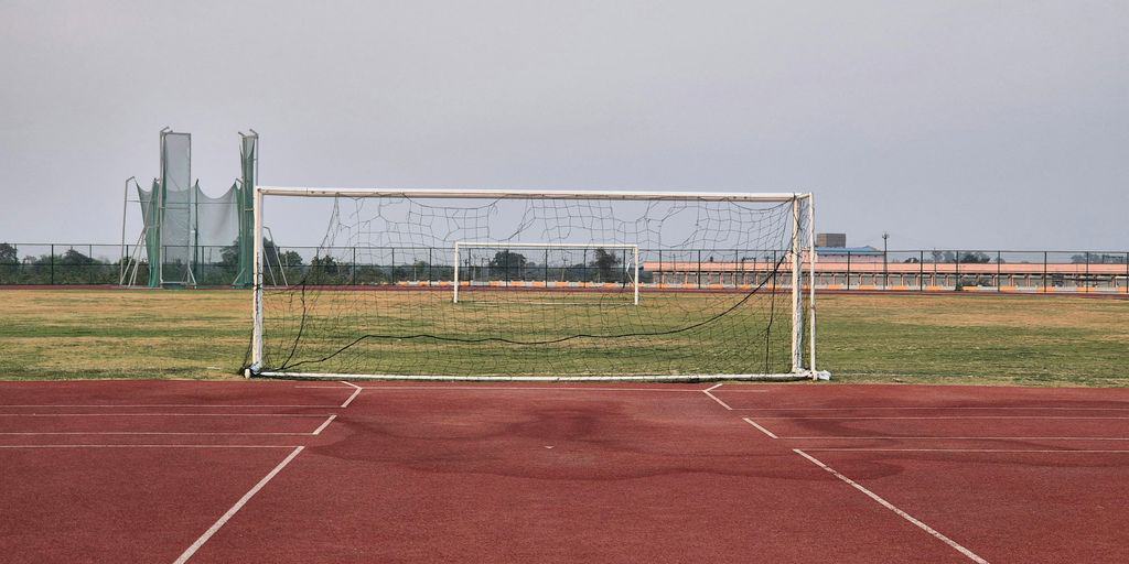 a soccer goal sitting on top of a soccer field